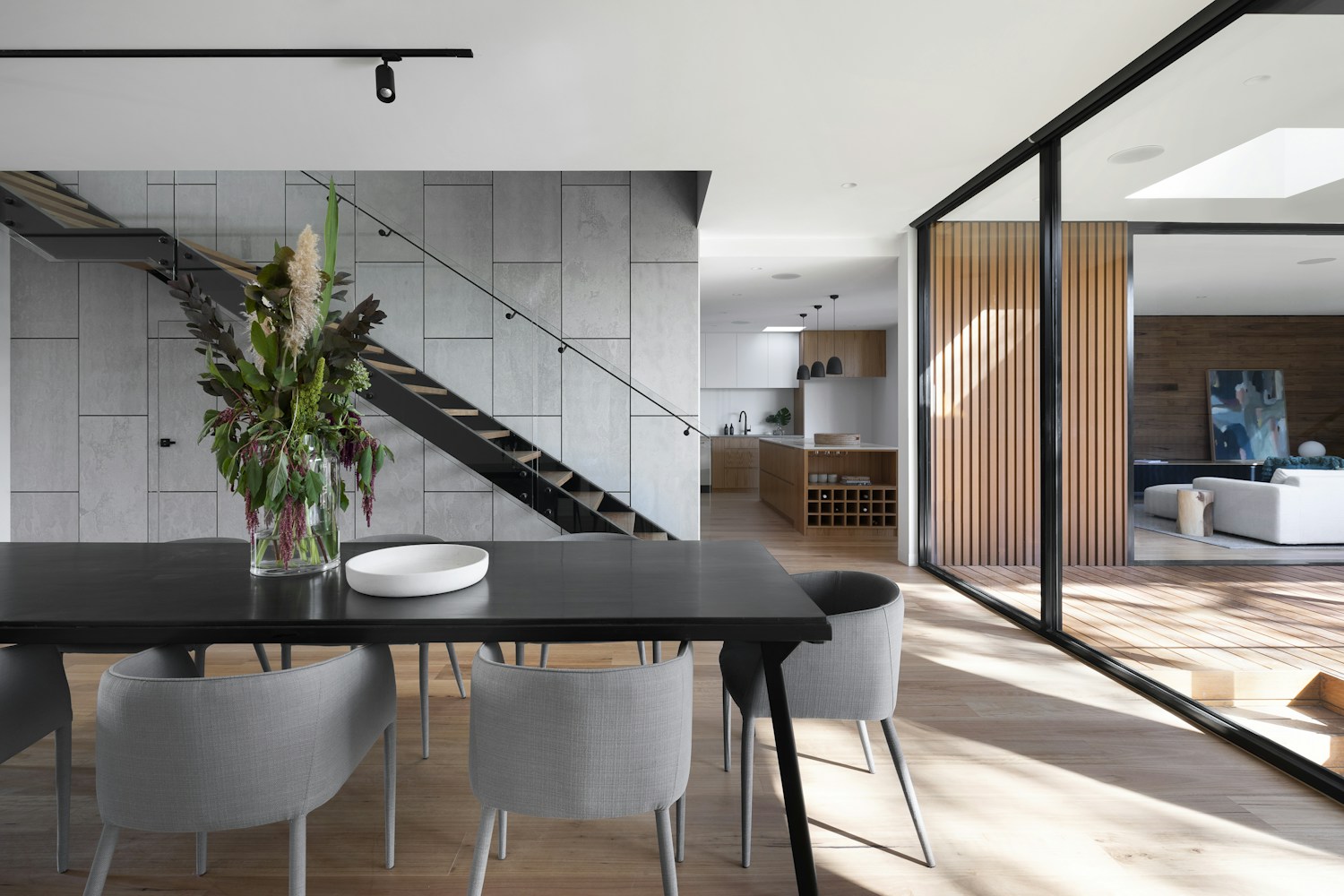 Contemporary living space with large windows and glass doors